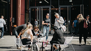 People sitting outside for chatting.