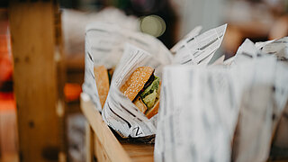 Freshly prepared burgers in paper wrapping