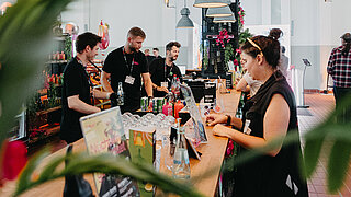 Participants networking at a bar at BRANDmania
