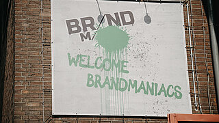 Sign reading "BRANDmania - Welcome BRANDmaniacs" at the entrance.